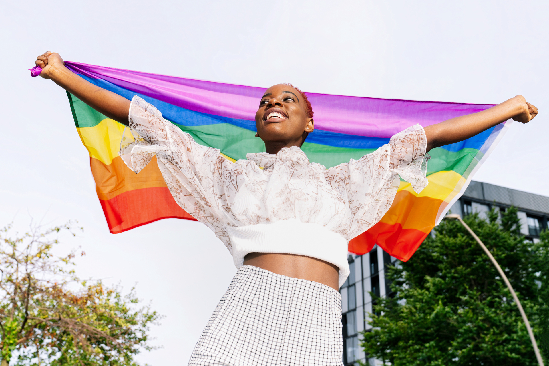 Carefree black woman with rainbow flag